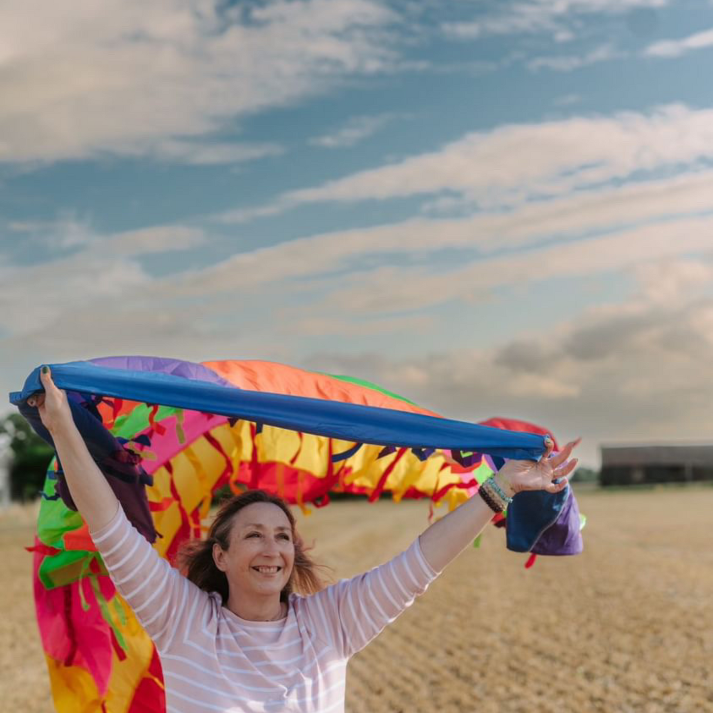 The Baby Class Expert, Elizabeth James, holding Rainbow Sensory Parachute with Ribbons
