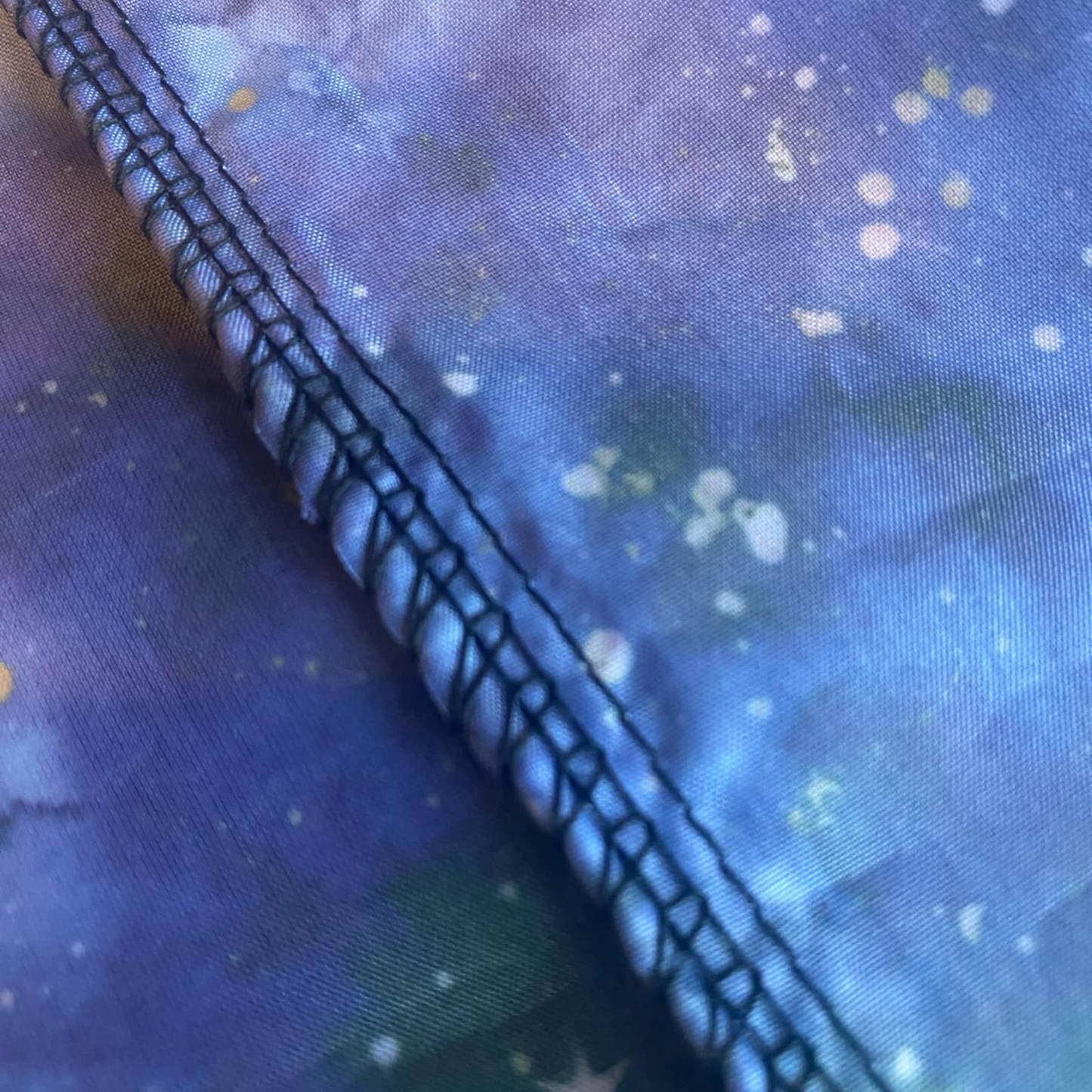 Close-up of triple-stitched seam on Sensory Parachute, showing durable handmade finish for safe use in baby classes.
