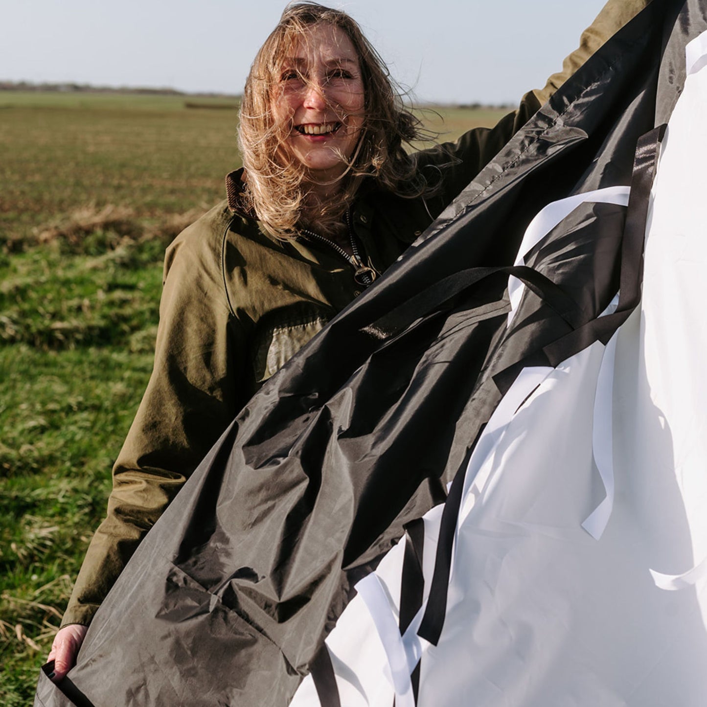 Sensory parachute being held outdoors, showing black and white contrast ideal for newborn and baby vision development