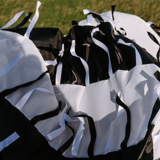 Detailed view of high-contrast black and white panels with satin ribbons used in sensory play sessions for babies