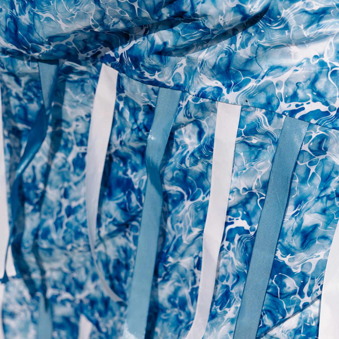 Ocean Sensory Parachute – limited edition baby class prop inspired by sea sunlight and waves. Handmade sensory parachute with blue and white ribbons for baby sensory and development play.