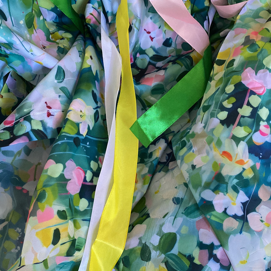 Sensory Parachute used in a baby development class with bright colourful ribbons and floral printed background