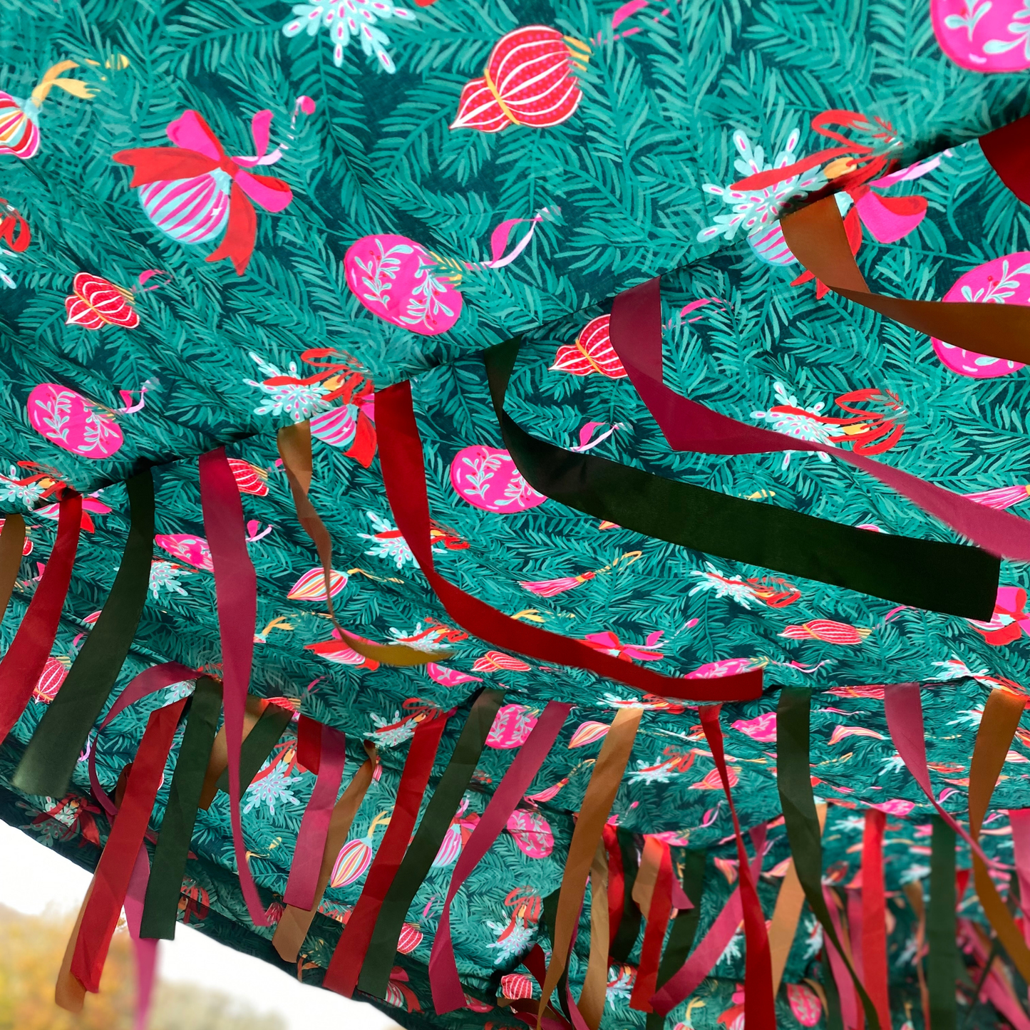 Underneath the Christmas Tree Sensory Parachute — 3 metre green parachute with Christmas tree branches and baubles print and over 200 ribbons for baby sensory classes.