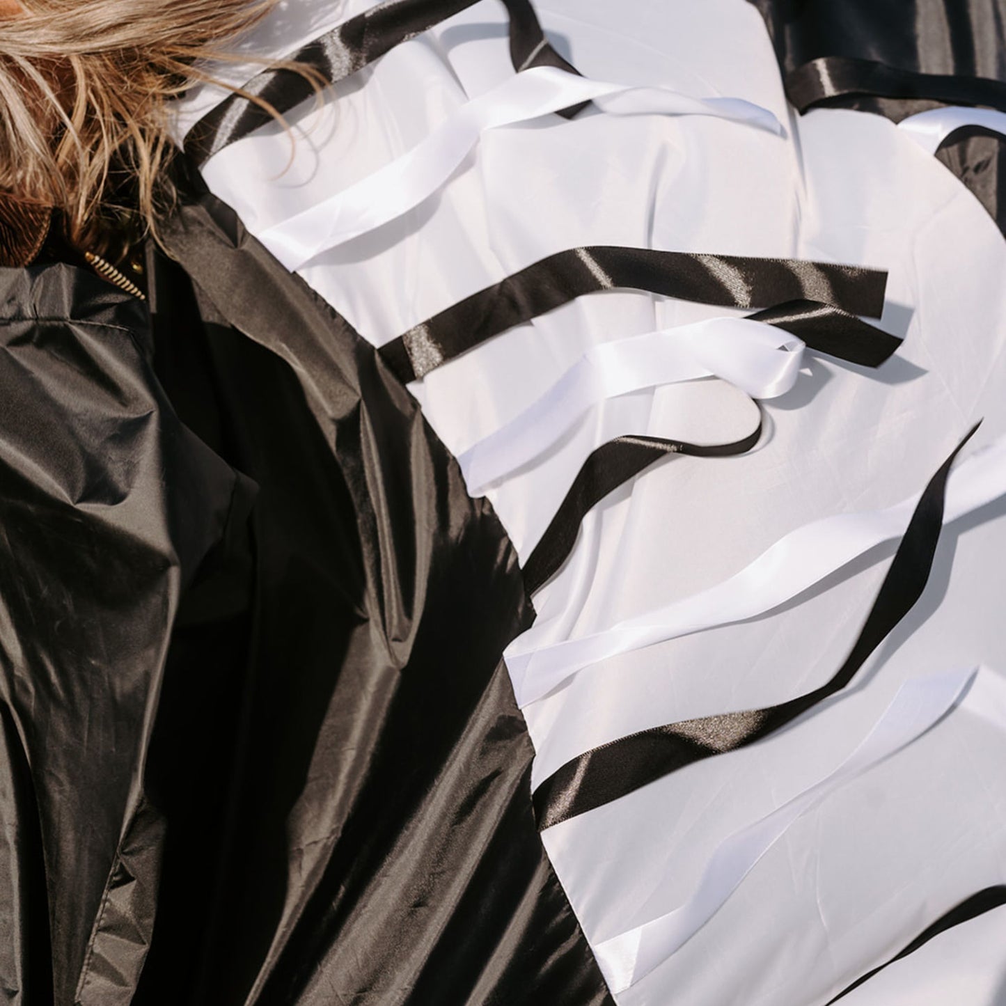 Close-up of satin black and white ribbons from a handmade sensory parachute used in baby and toddler classes.