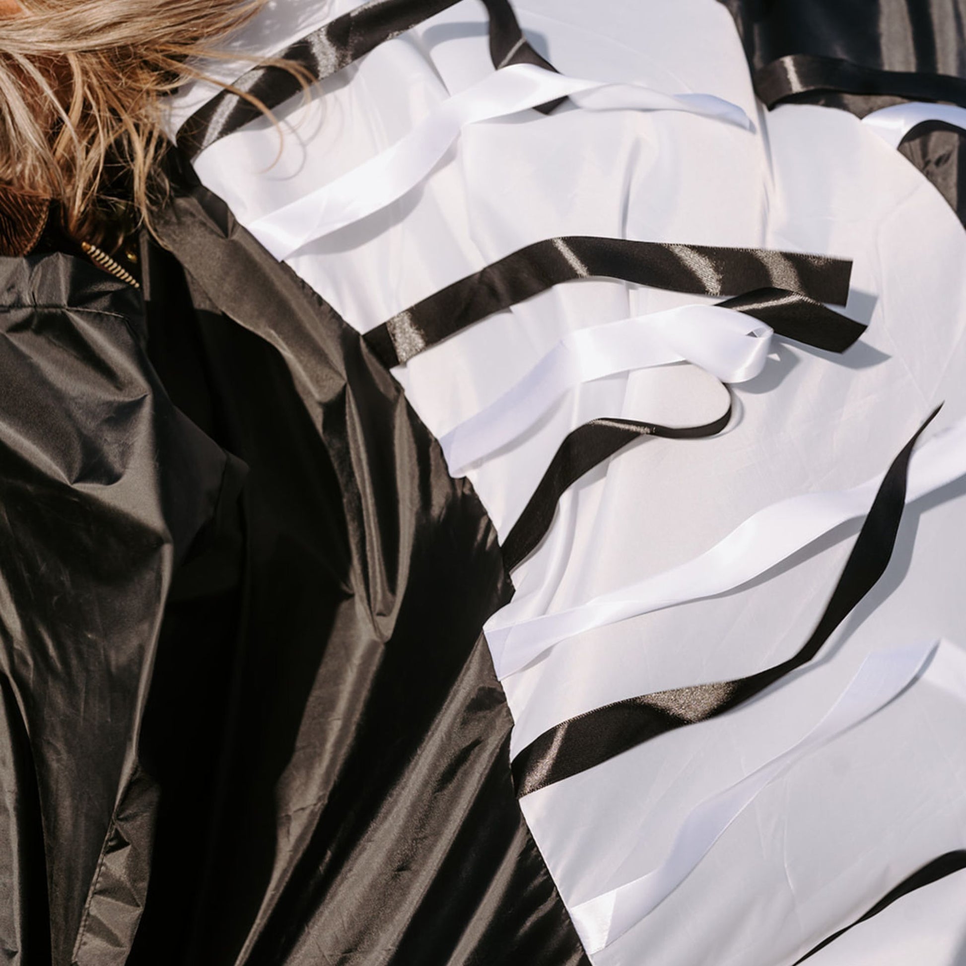 Close-up of satin black and white ribbons from a handmade sensory parachute used in baby and toddler classes.