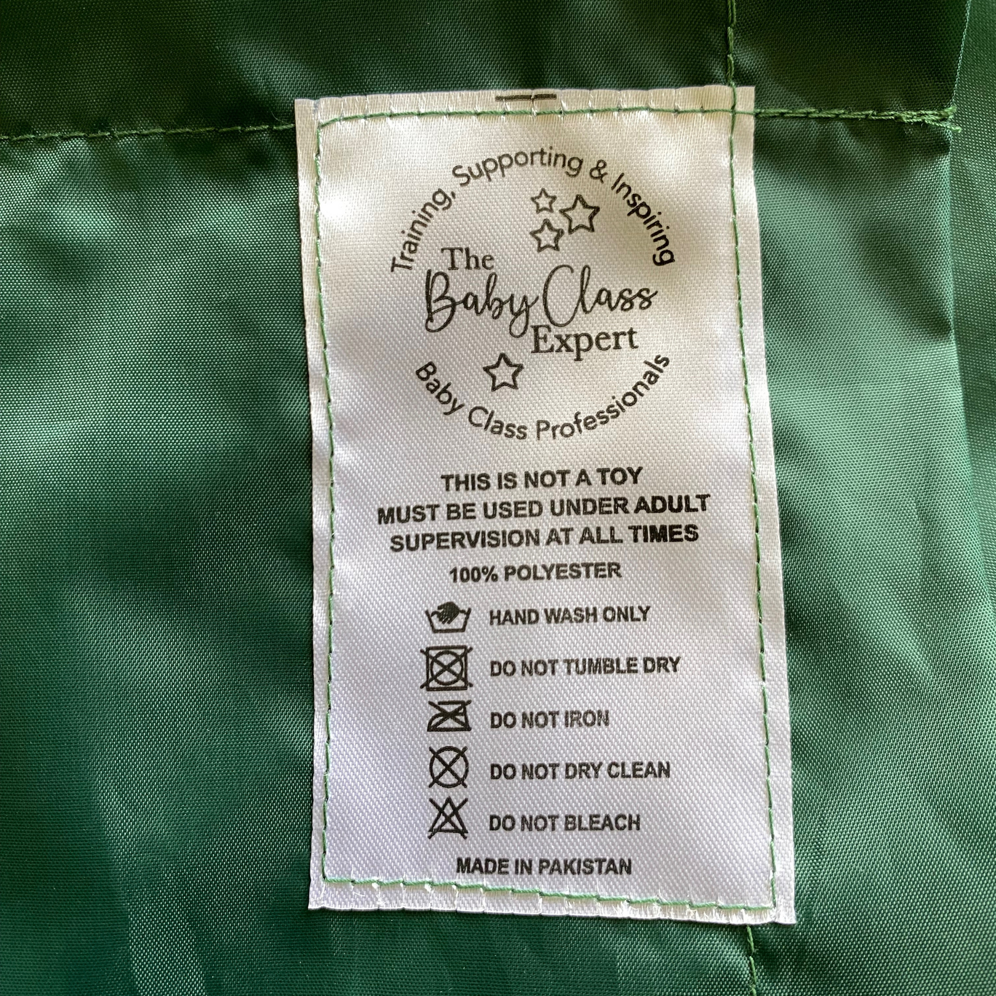 close up of the label jungle sensory parachute giving care instructions