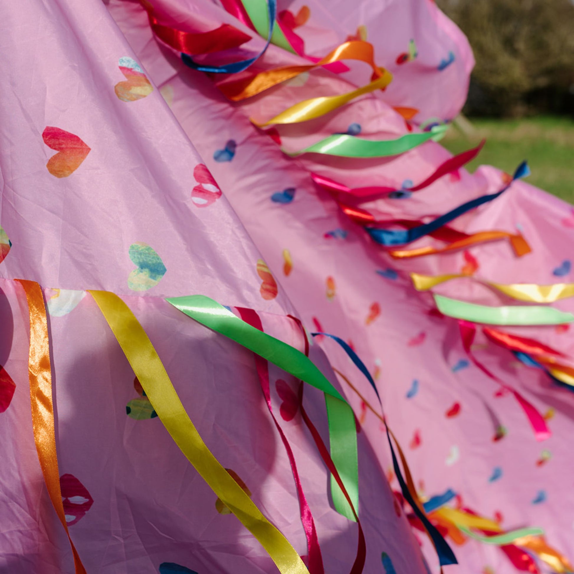 Detailed view of the Love is in the Air pink Sensory Parachute with multicoloured ribbons and heart-pattern fabric.