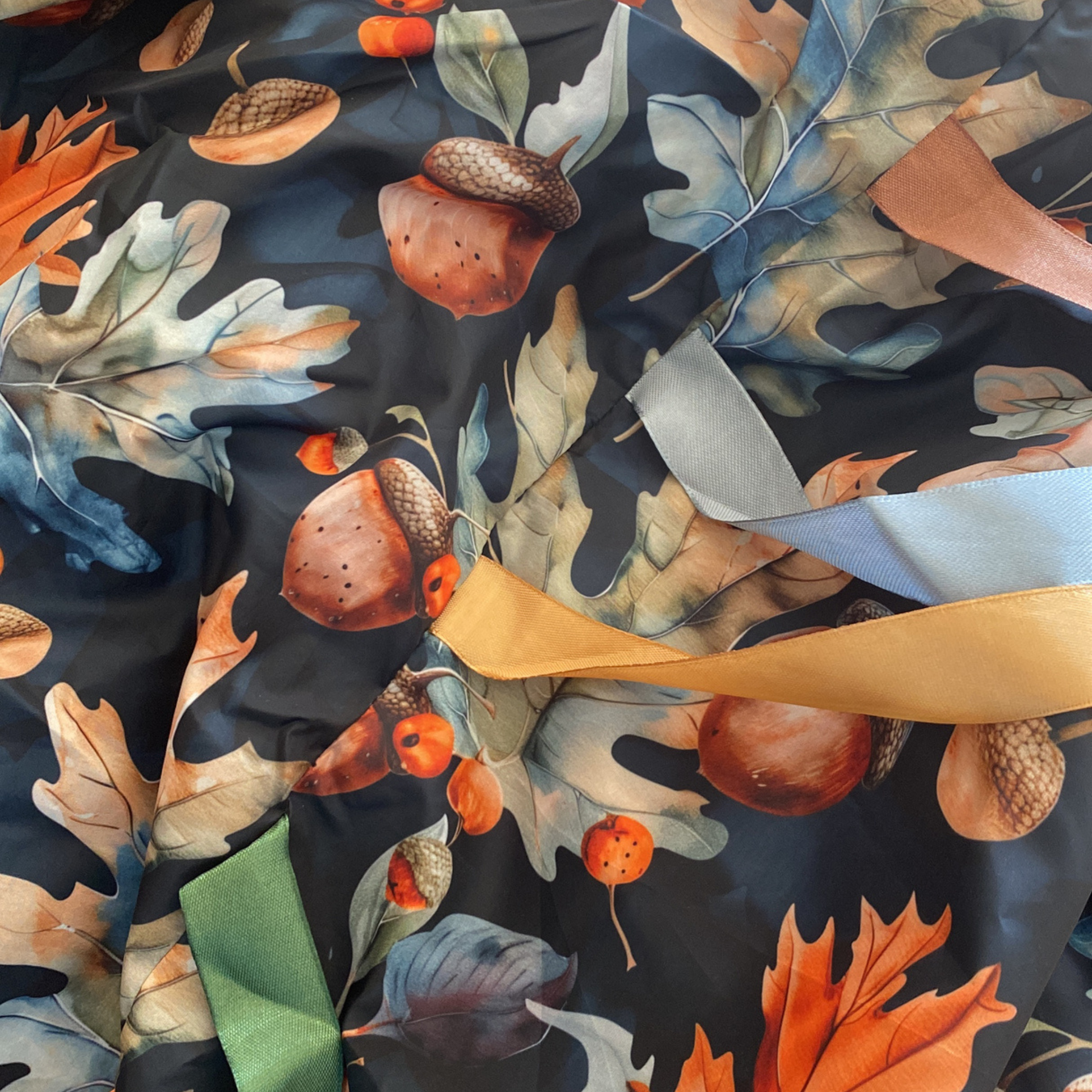 Close up of the oak and acorn sensory parachute fabric and ribbons designed for  multi sensory baby classes