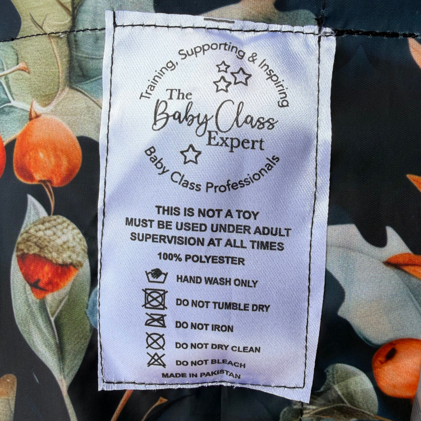 close up of the oaks and acorns sensory parachute label designed for multi sensory baby classes