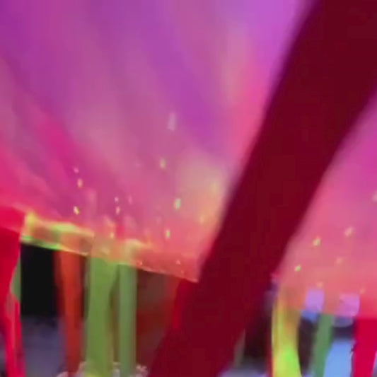 RainbowSensory Parachute in motion, with over 200 shimmering red, yellow, pink, green, orange, purple & blue ribbons flowing during a baby class activity.