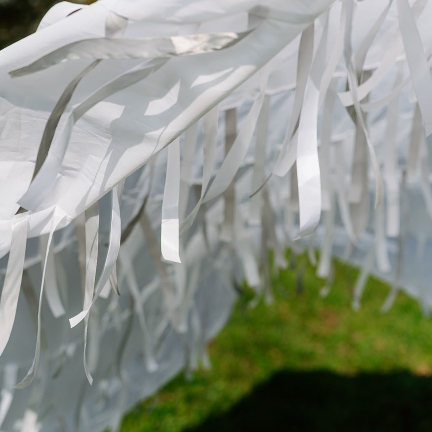 Close-up of Snowfall white sensory parachute ribbons and fabric used in multi-sensory baby classes.