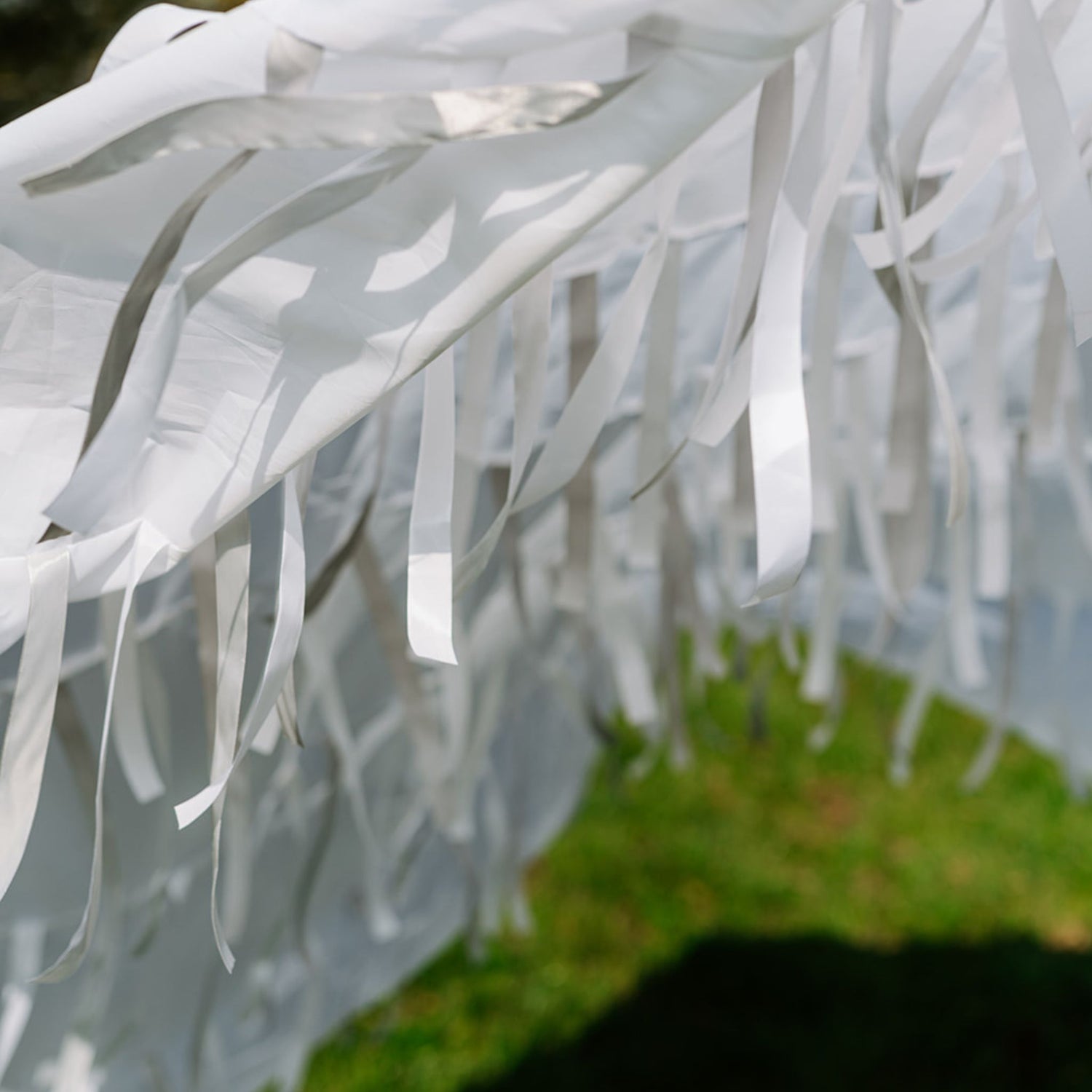 Close-up of Snowfall white sensory parachute ribbons and fabric used in multi-sensory baby classes.
