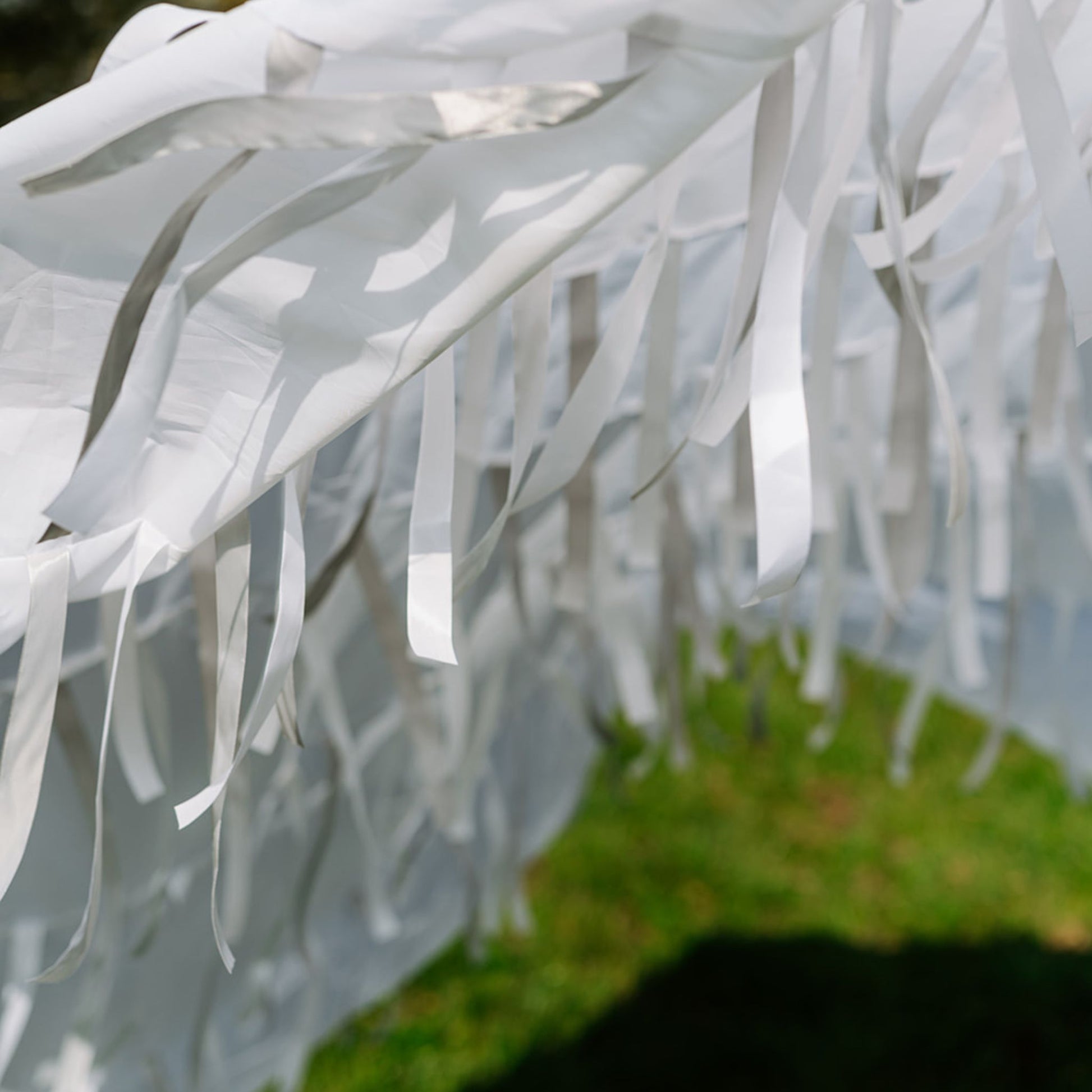 Close-up of Snowfall white sensory parachute ribbons and fabric used in multi-sensory baby classes.