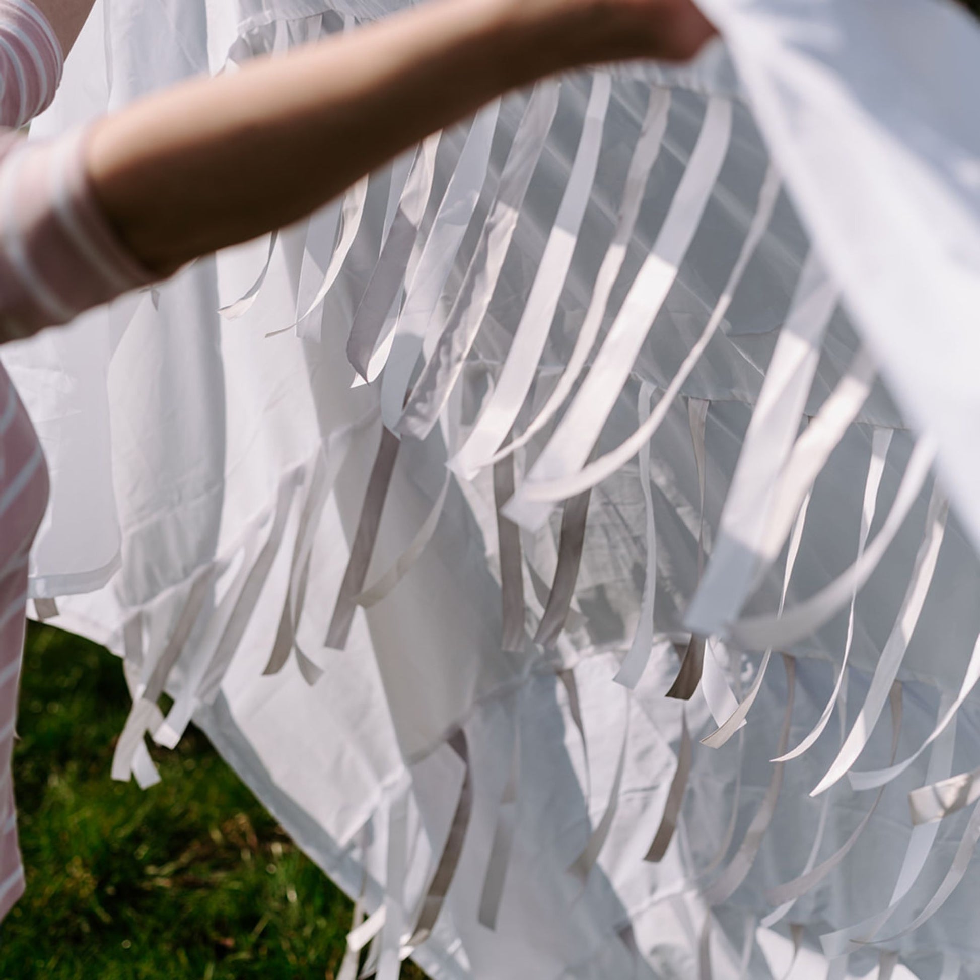 Folded Snowfall sensory parachute showing panels and ribbons ready for professional use in baby development classes