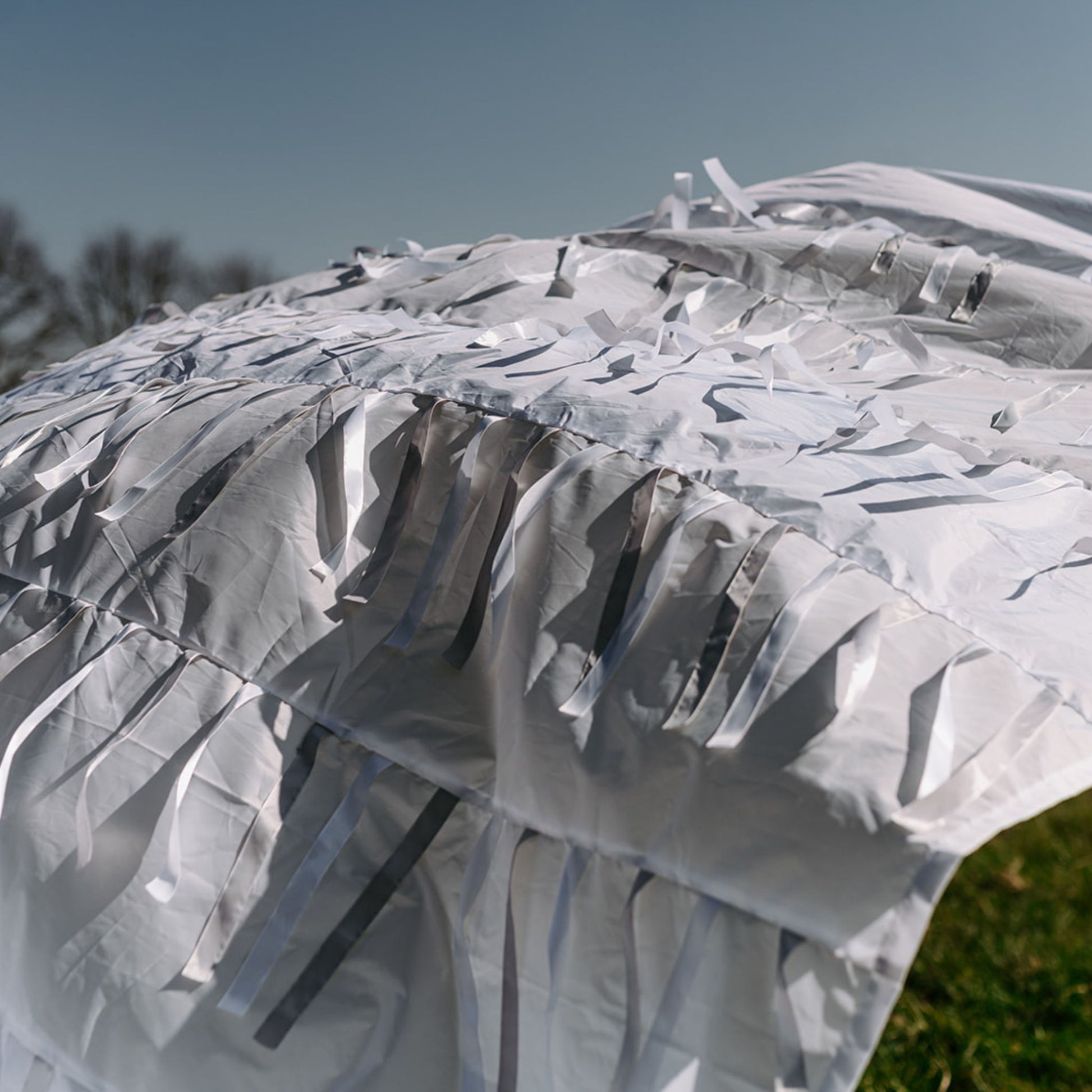 Snowfall sensory parachute moving in the breeze, showing delicate ribbons and soft light used for sensory development