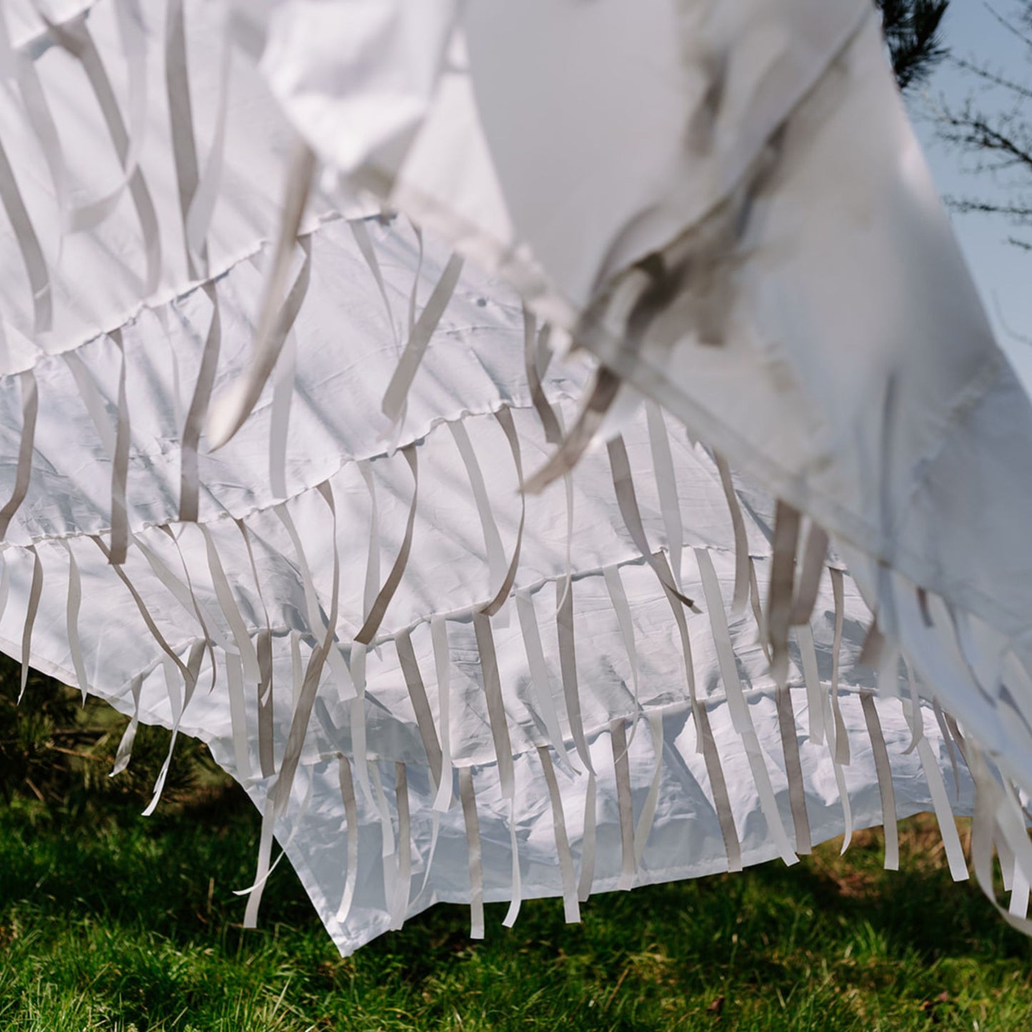 Textured detail of Snowfall sensory parachute with shimmering white ribbons for early years sensory play.