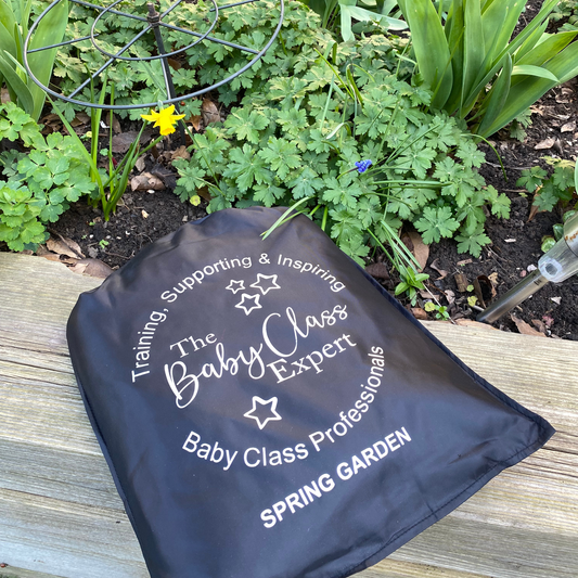 Spring Garden sensory parachute storage bag placed outdoors in a garden setting for baby class equipment